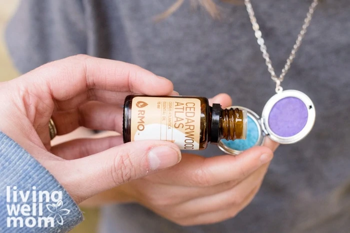 adding essential oils for focus into a diffuser necklace