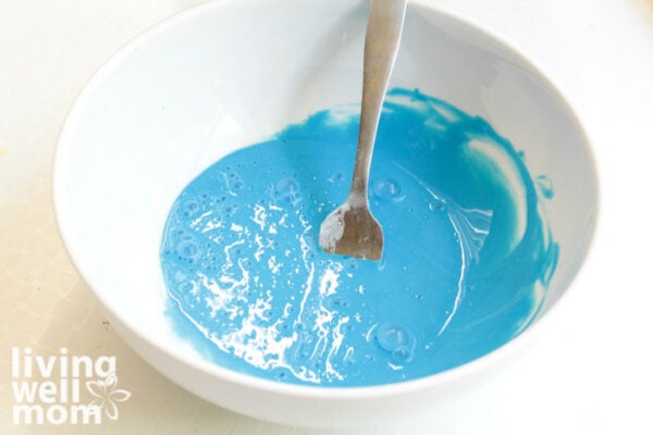Bowl of blue paste being made into fluffy slime