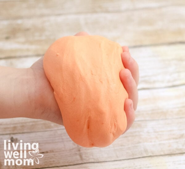 Child holding large ball of diy putty
