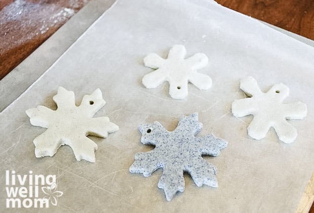 baking DIY snowflake cut outs on a parchment lined pan