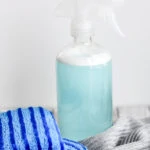 blue spray bottle for cleaning shower with sponges