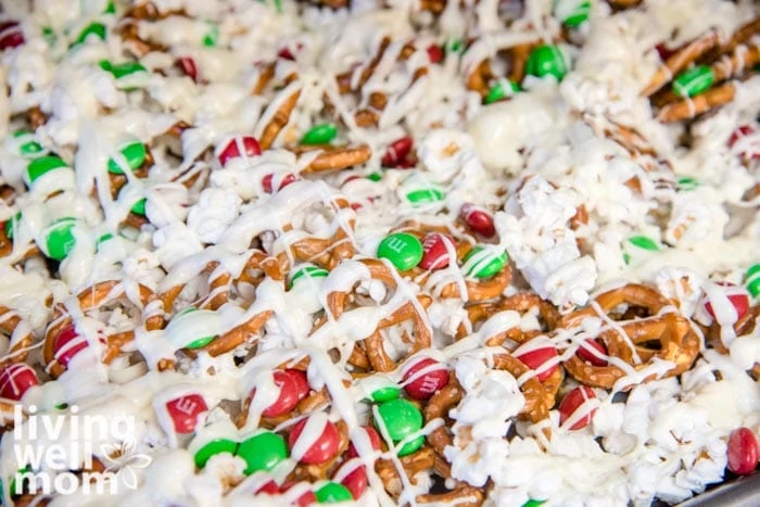 Popcorn mixed with m&ms and pretzels, then drizzled with white chocolate