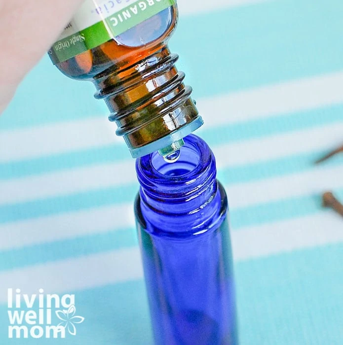 essential oil being added to a roller bottle