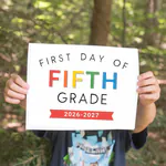 Boy holding a first day of fifth grade printable sign