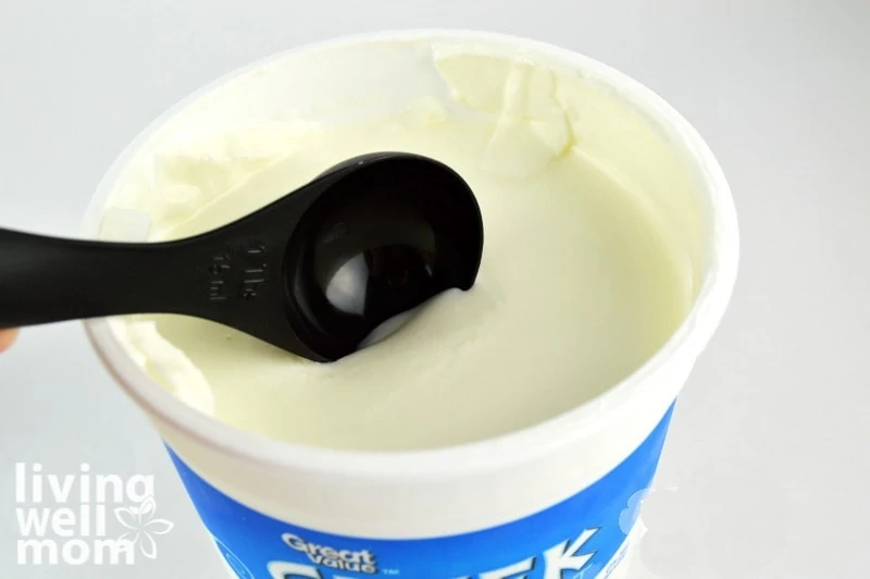 scooping up greek yogurt for making homemade finger paint