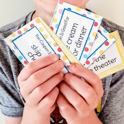 boy holding reading reward coupons