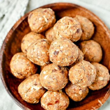 Pile of peanut butter energy bites in a wooden bowl