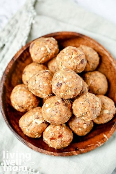 Pile of peanut butter energy bites in a wooden bowl