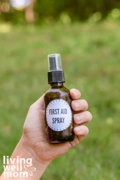 Child holding a bottle of homemade first aid spray