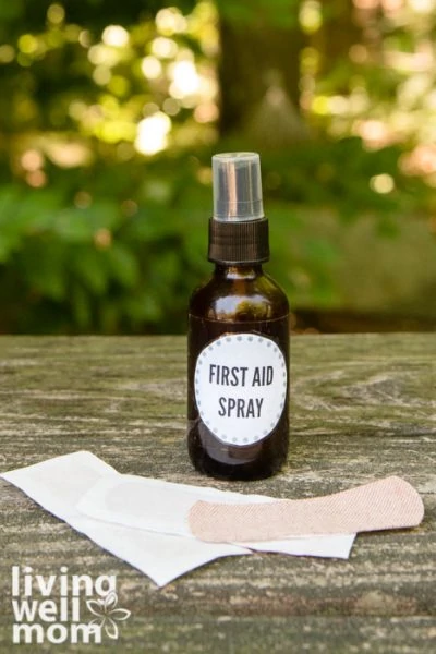 brown glass spray bottle first aid spray with a bandage on wood with woods background