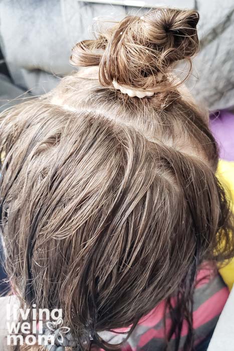 girls hair tied up for combing out lice