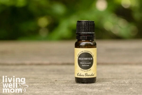 bottle of helichrysum essential oil for dry skin on a table