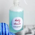 blue daily shower cleaner spray bottle with sponges and cleaning cloths