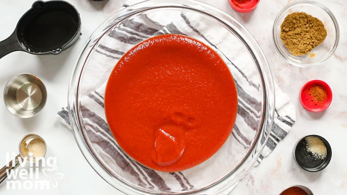 taco sauce in a bowl with spices surrounding it