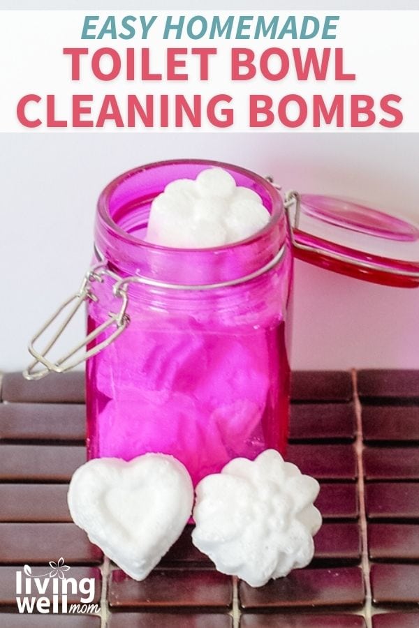 heart and flower shaped toilet bowl cleaner fizzing tablets leaning on a pink air tight container