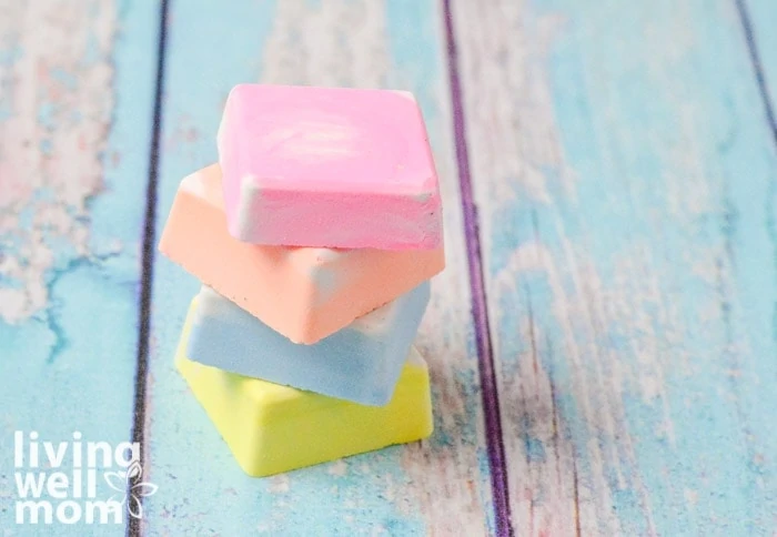 Colorful squares of DIY sidewalk chalk on a wooden surface.