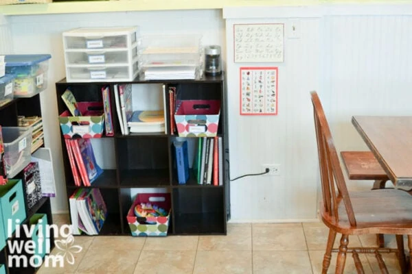 Organized homeschool supplies in the corner of a kitchen