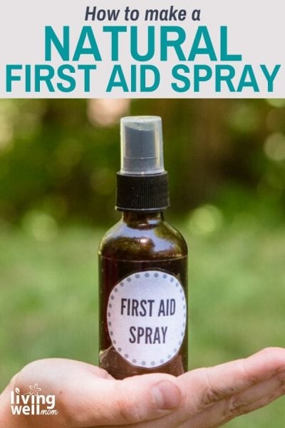 brown glass spray bottle first aid spray with a bandage on wood with woods background