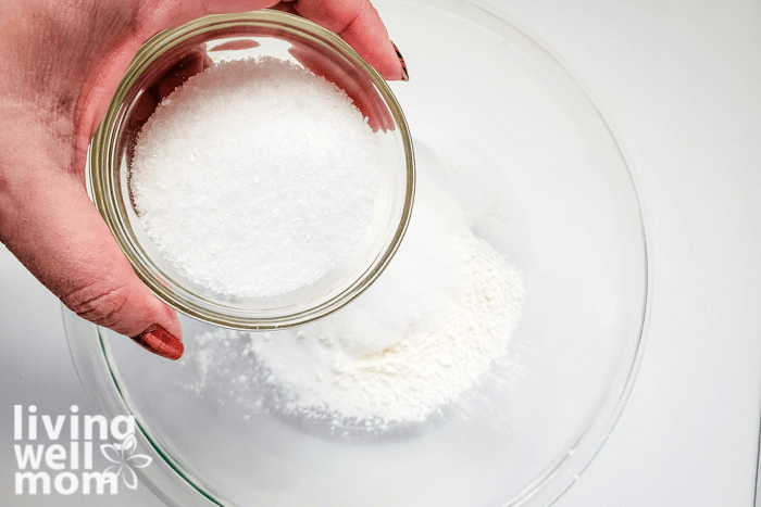 Dry ingredients for DIY salts being added into a mixing bowl.