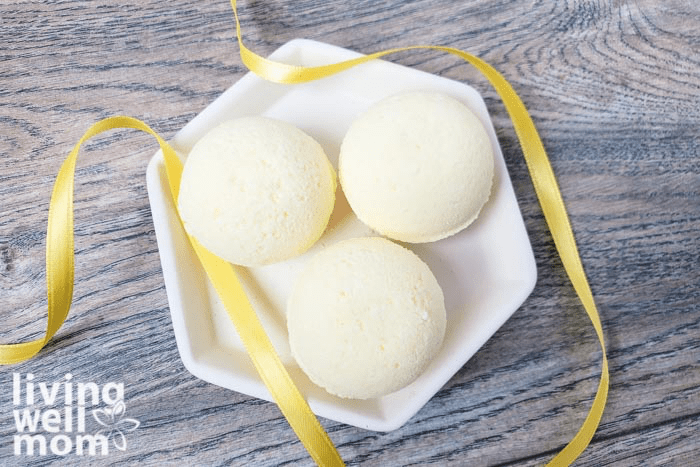 A tray of bath bombs with a yellow ribbon surrounding them.