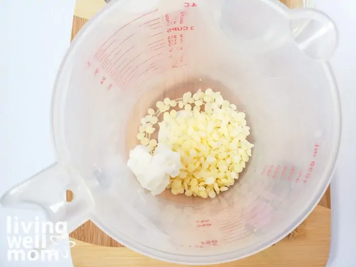 Beeswax and shea butter in a measuring cup to be melted together. 