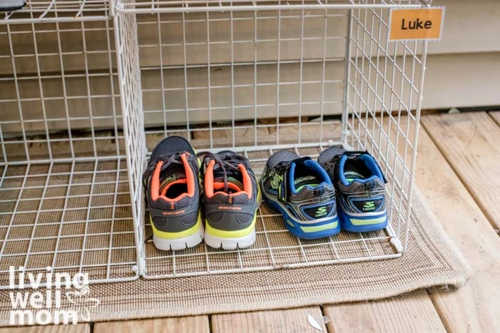 2 pairs of kids shoes side by side in a rack