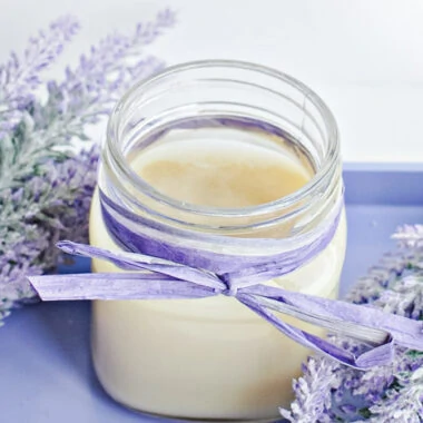 Mason jar with DIY foot balm nestled in lavender