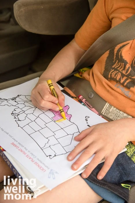 Kid learning geography by coloring states in a license plate game