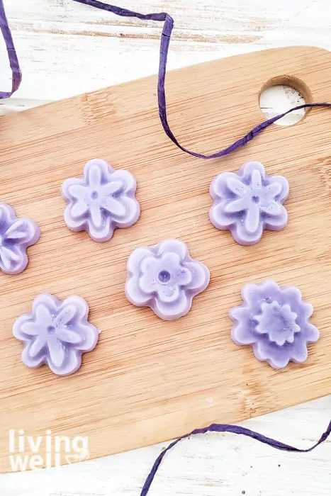 Six shea butter lotion bars in flower shapes, made from a DIY recipe.