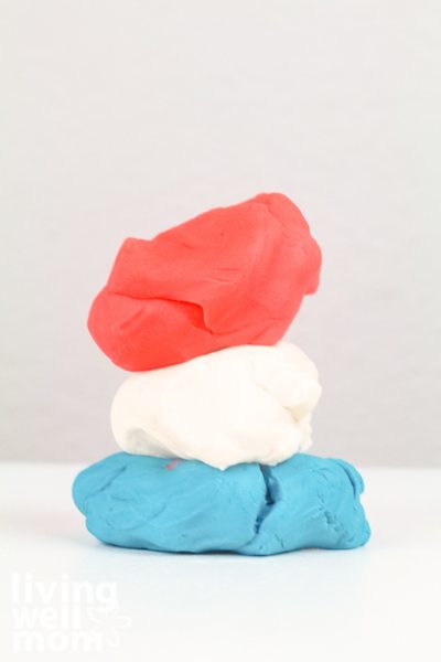 Stack of red, white, and blue playdough piled together