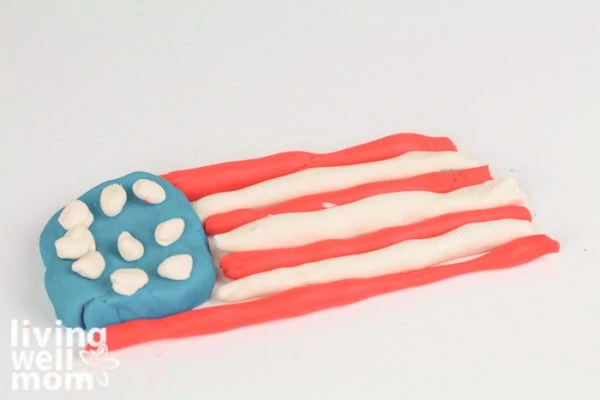 American flag made out of playdough on a white background.