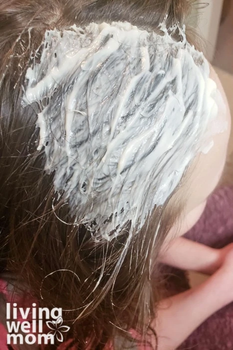 Mayonnaise being used as a lice treatment at home for child.