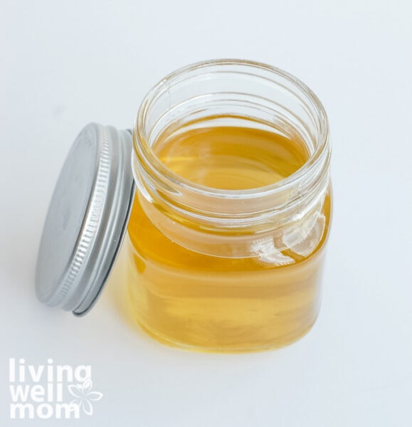 mason jar filled with melted coconut oil for feet and assorted essential oils