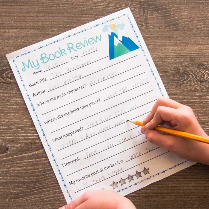 child writing on my book review worksheet