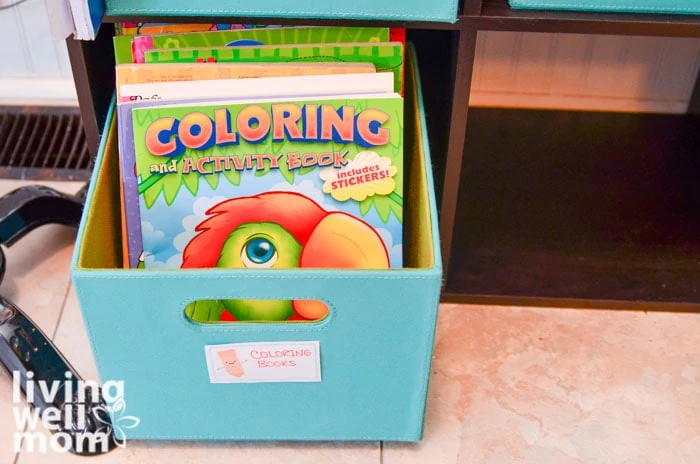 storing kids coloring books in a blue cube 
