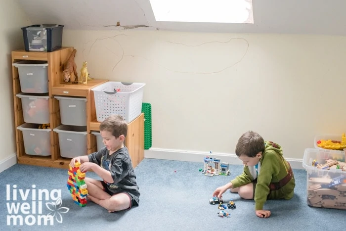 2 boys playing with toys on the floor