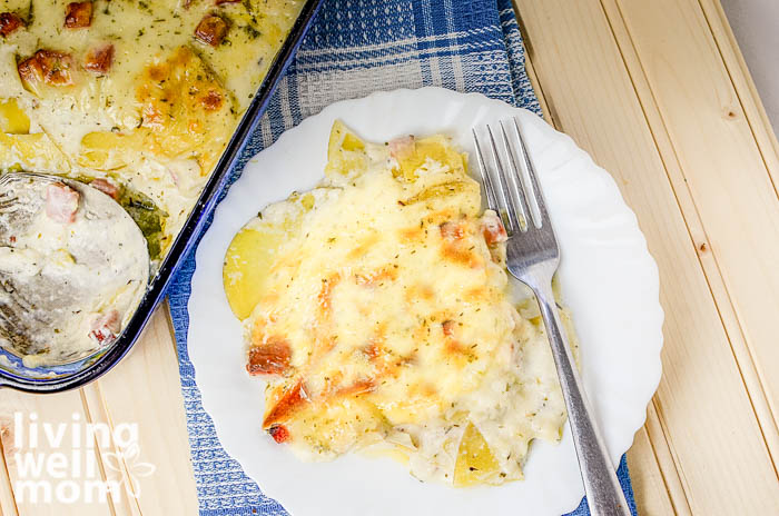 plate of scalloped potatoes and ham with a fork