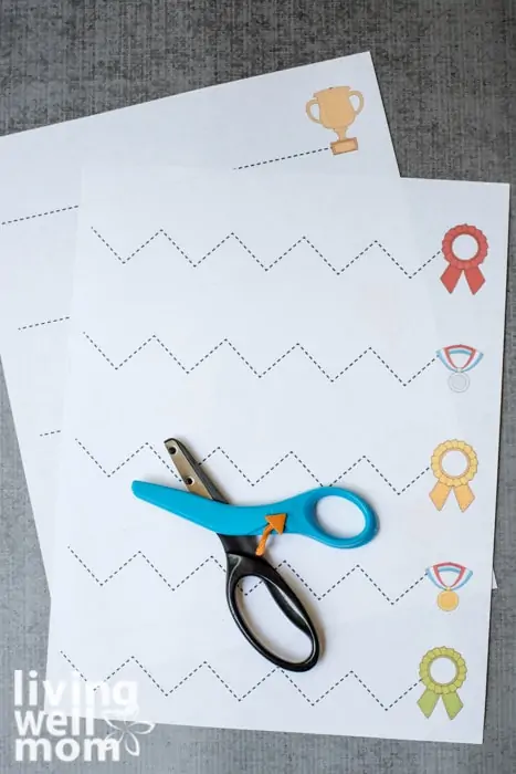 Fiskars kids scissors setting on top of printable cutting practice sheets for kids.