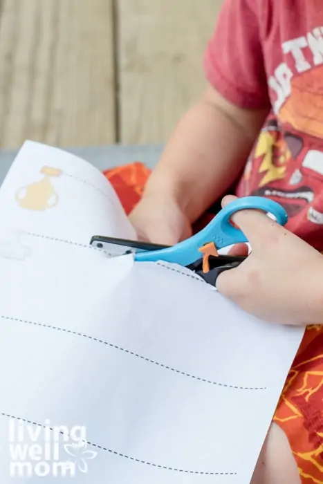 Scissor practice sheets being cut by a preschooler. 