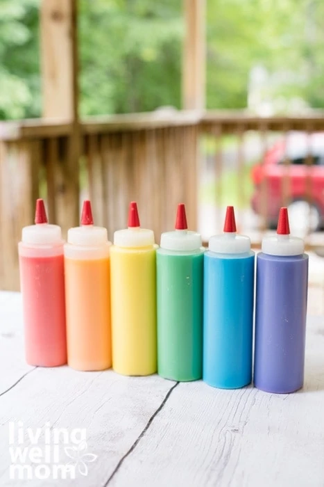 Plastic bottles of multi-colored chalk paint for using in outdoor activities for kids. 