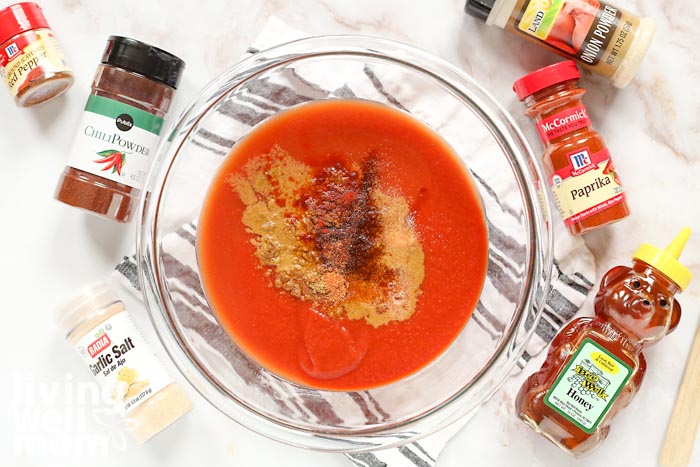 homemade taco sauce recipe with spices surrounding the bowl