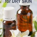 essential oil bottles with white jasmine flowers for dry skin